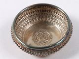 a silver bowl that is sitting on a table