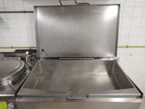 a stainless steel sink in the middle of a kitchen