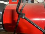 a red fire extinguisor sitting on the ground