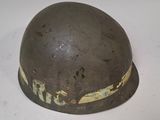an old helmet is sitting on top of a white surface