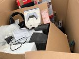 a cardboard box full of electronic equipment in the street