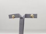 a close up of a pair of earrings on a stand