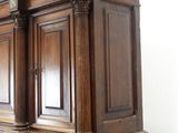 a large wooden cabinet with two doors on top of it
