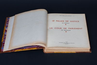 an open book sitting on top of a table next to a black table