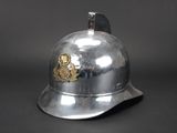 a silver helmet with a gold emblem on it