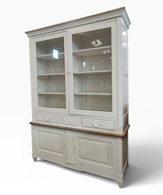 a white china cabinet with glass doors and a wooden top