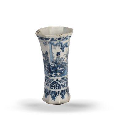 an old blue and white vase with a man in a boat on the water