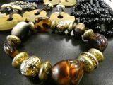 a bracelet with beads and wooden beads on a table
