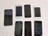 several cell phones are lined up in a row on a table