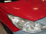 a close up of a car with a red hood