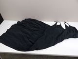 a black shirt on a white table in a room