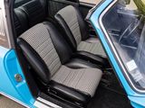 a small blue car with two black seats in it