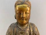statue of a woman holding a bowl of food in her hands