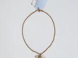 a gold chain bracelet with a bow charm on it