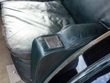 a guitar case sitting on the back of a couch