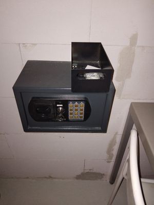 a metal box with a combination lock on it in a bathroom