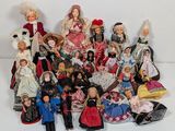 a lot of dolls that are sitting together on a table