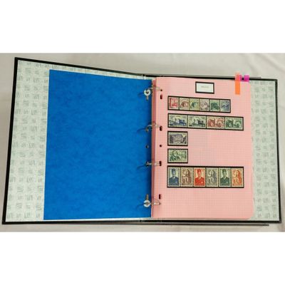 a pink binder with stamps on it and a blue cover