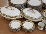 a lot of plates and bowls that are on the table