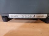 a close up of the back of a microwave on a table