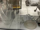 a glass display case with a lot of glass items on it
