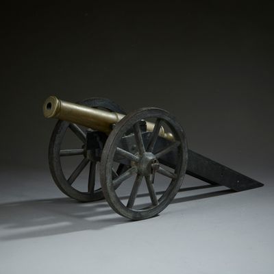 un vieux canon posé sur une charrette en bois