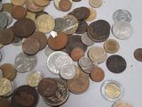a pile of coins sitting on a white surface