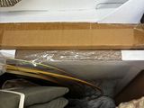 a box full of clothes and other items sitting on a shelf