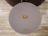a white toilet with a yellow button on it