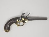 an old gun that is on display on a white surface