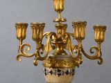 a gold candelab with five candles on it