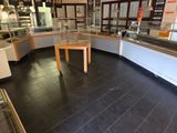 an image of a store with a counter and a display case