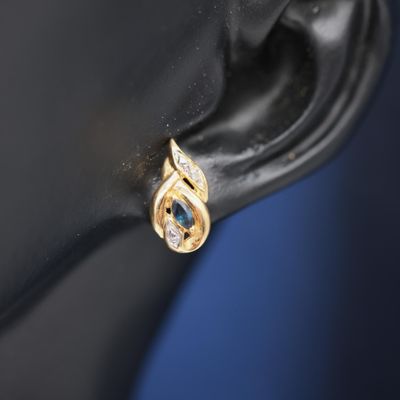 a close up of the ear of a woman wearing a gold and diamond ear cuff