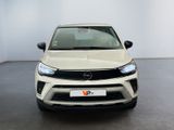the front view of a white car parked in a room