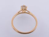 a close up of a gold ring with a single stone