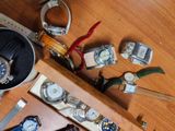 a lot of watches on a wooden table with a watch case
