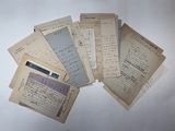 several old papers are stacked on top of each other on a table