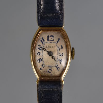 a close up of a wrist watch with a blue strap