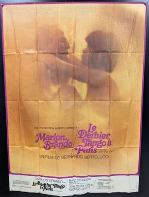 a movie poster for the film, le marbo, featuring a man kissing a woman in front of a