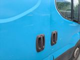 a picture of a blue van parked on the side of the road