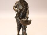 bronze statue of a boy with a basket of flowers