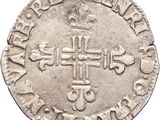 an old silver coin with a cross on it
