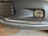 a close up of a car ' s headlight and front bumper