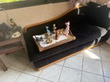 a tray with figurines on top of a black couch