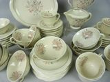 a lot of dishes and cups on the table