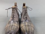 pair of men ' s brown leather shoes with laces on them
