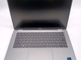 an open laptop computer sitting on top of a white table