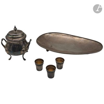 a silver tea set with four cups and a tray