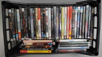 une étagère noire sur laquelle sont posés plusieurs DVD