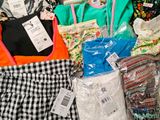 a pile of clothes and bags that are on a table